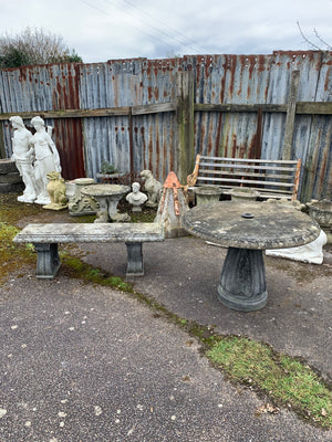 A cast stone garden bench