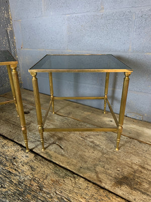 A brass and glass Hollywood Regency nesting pair of tables