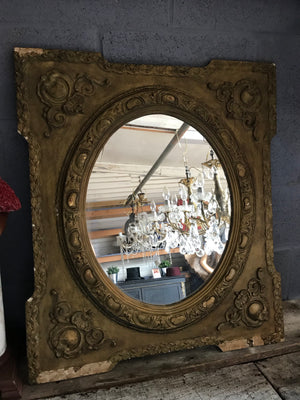 An ornate French rectangular gilt mirror with oval plate