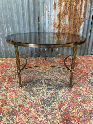 A rare circular brass and glass Hollywood Regency coffee table