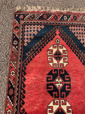 A Persian red & blue ground rectangular rug
