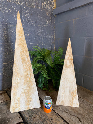 A pair of very large travertine obelisks