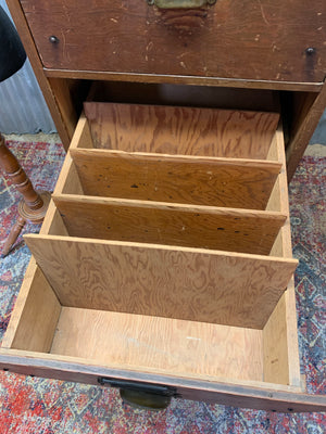 A WWII era wooden filing cabinet