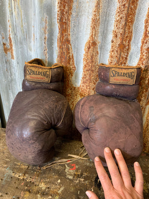 A vintage pair of brown leather Spalding boxing gloves