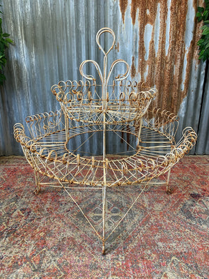 A pair of white wirework demi-lune plant stands