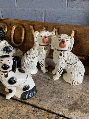 A collection of four pairs of Staffordshire and Beswick fire dogs