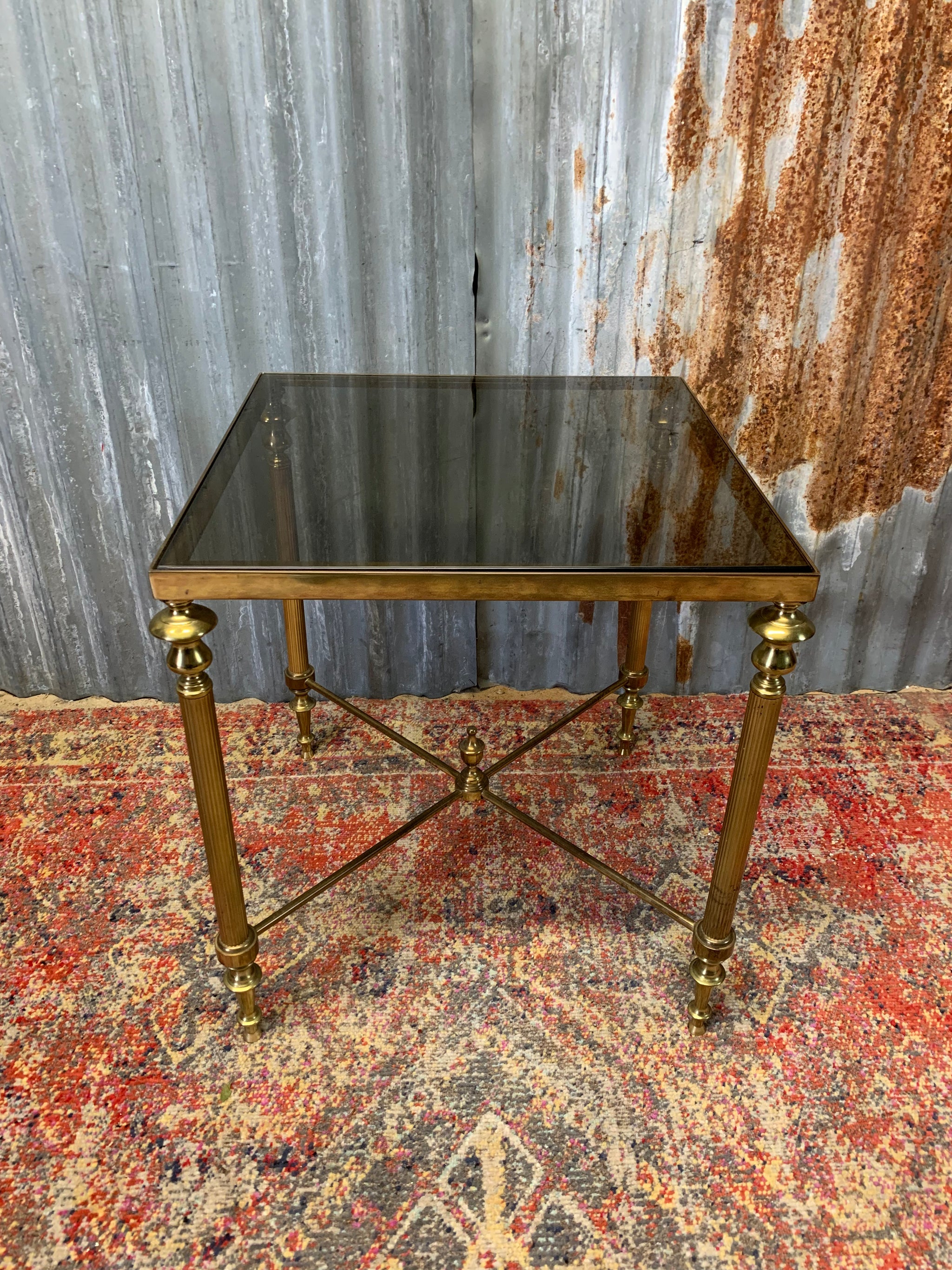 A brass and glass Hollywood Regency side table Belle and Beast