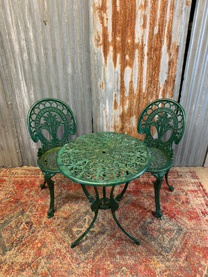 A green garden table and chairs set