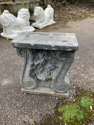 A cast stone garden bench