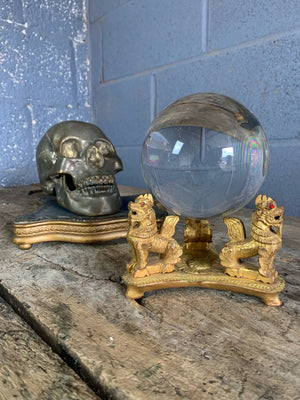 A fortune teller's crystal ball on a giltwood stand