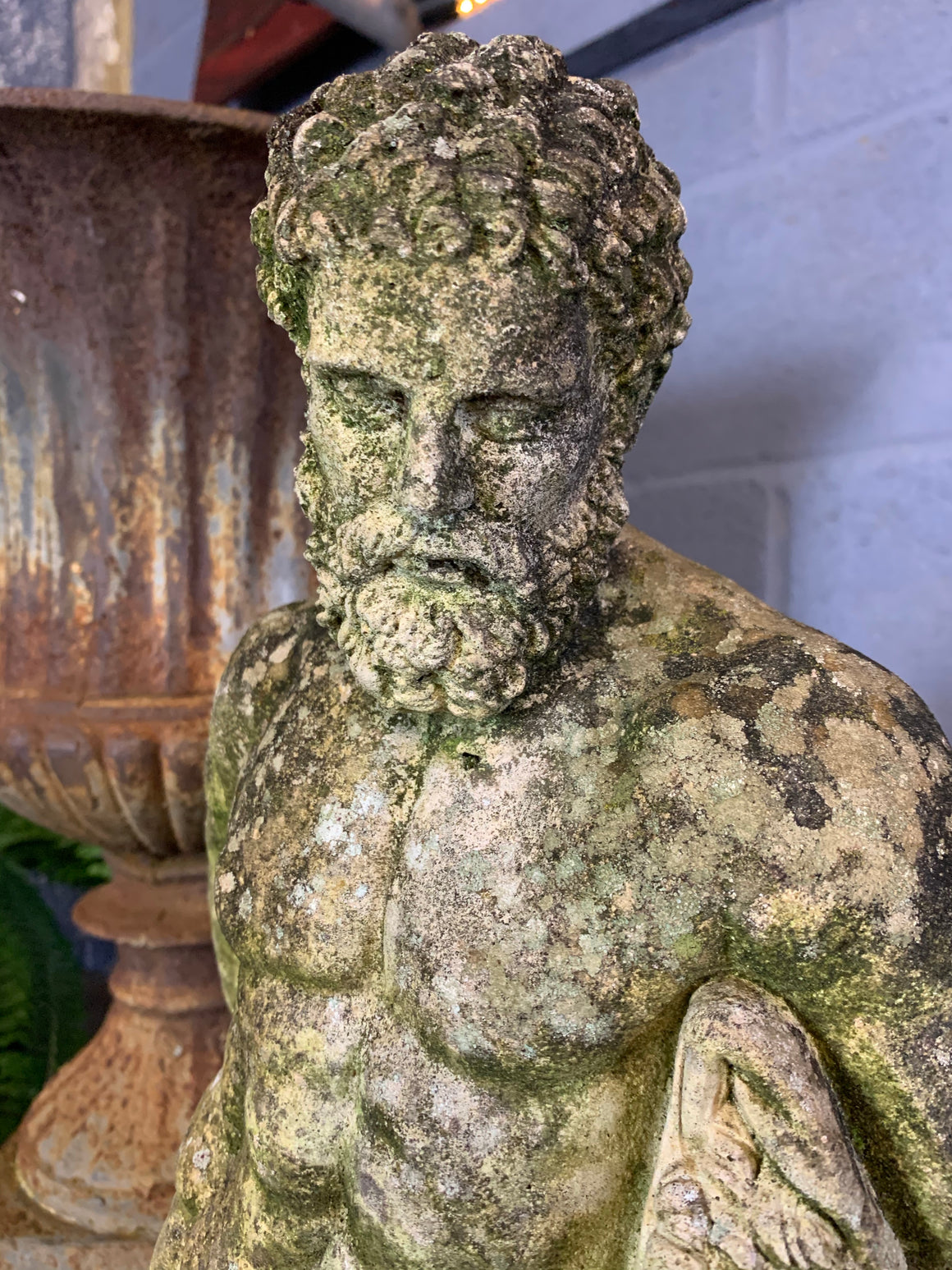 A weathered statue of Hercules
