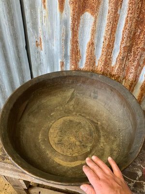 A very large hand beaten copper bowl
