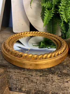 A pair of large gold convex mirrors with rope twist detailing