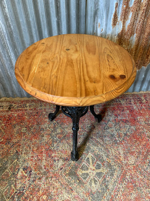 A cast iron Britannia garden table with oak top