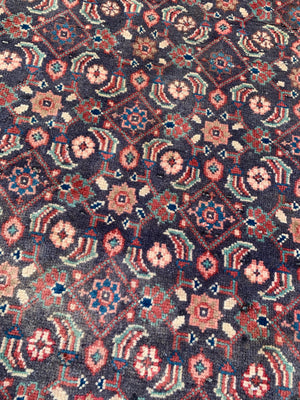 A Persian blue and brown ground rectangular rug