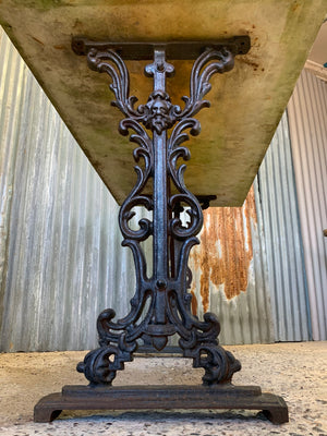 A cast iron garden table with marble top