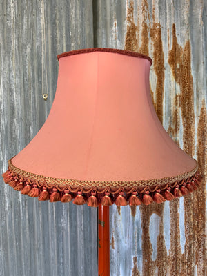 A red lacquer chinoiserie standard lamp with tasselled shade
