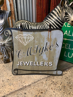 A metal trade sign for C M Sykes Jewellers