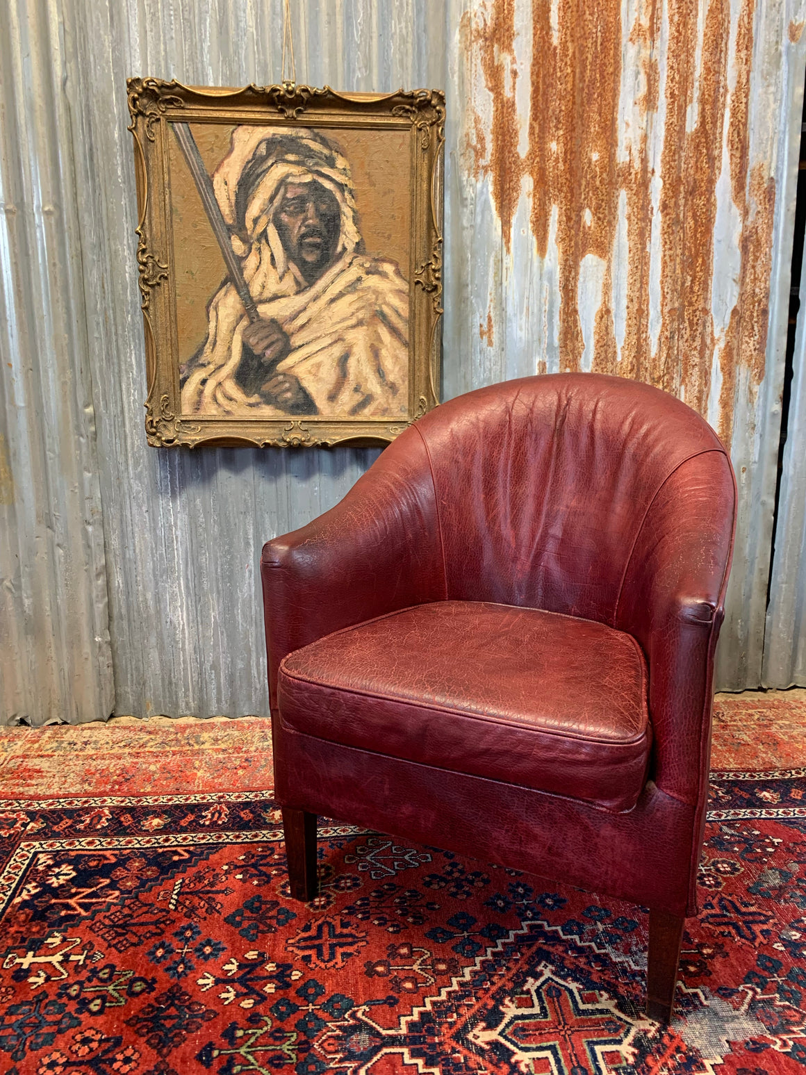 An oxblood leather tub chair