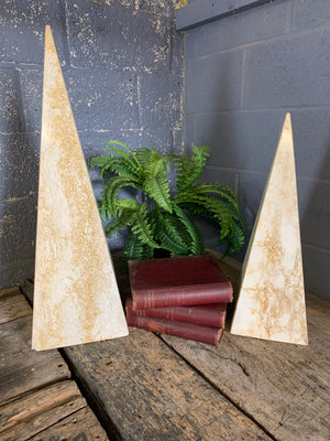A pair of very large travertine obelisks