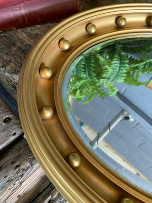 A large 19th century Regency-style oval mirror