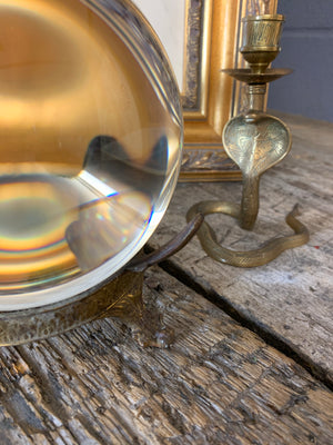 A fortune teller's crystal ball on a bronze stand