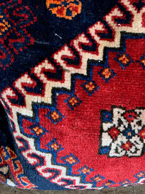 A pair of Persian carpet cushions