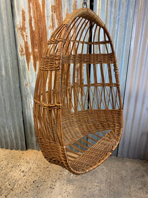 A rattan hanging egg chair