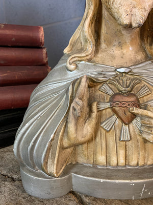 A plaster bust of Jesus with flaming Sacred Heart