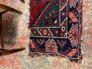 A large rectangular Persian carpet floor cushion