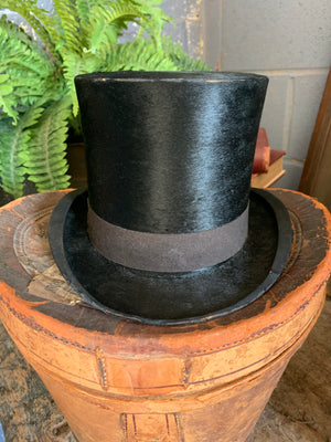 A Victorian black top hat and leather hatbox