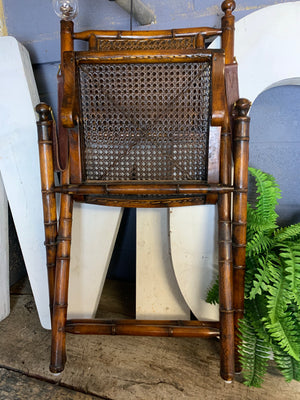 A faux bamboo carved hardwood folding campaign chair