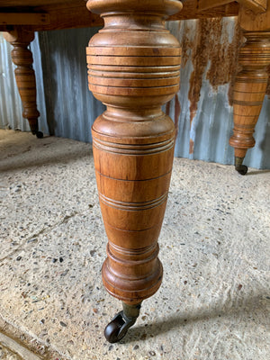 A Victorian scrubbed pine kitchen or dining table on castors