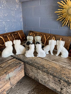 A collection of four pairs of Staffordshire and Beswick fire dogs