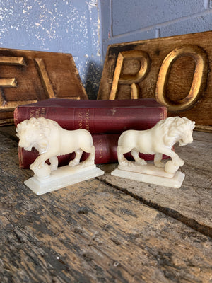 An opposing pair of Grand Tour alabaster Medici lions