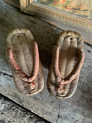 A pair of wood and straw geta