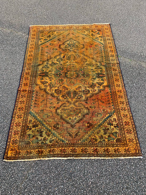 A large gold Persian rectangular rug - yellow/mustard tones