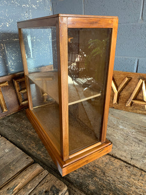 A glass table top shop display cabinet