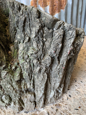 A cast stone faux bois planter