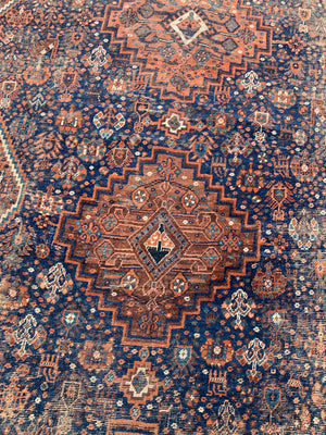 A very large hand woven Persian blue and orange rectangular rug- 300cm x 225cm