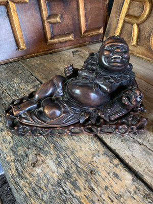 An opposing pair of hand carved reclining buddhas in rosewood