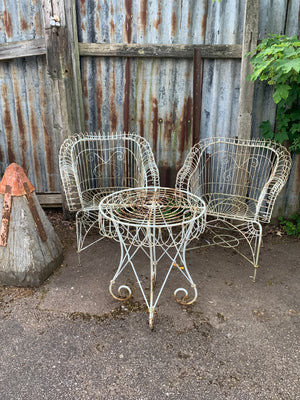 A cast iron wirework garden set