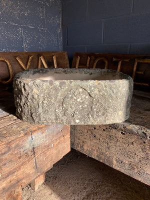 A large cast stone basin trough
