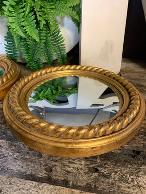 A pair of large gold convex mirrors with rope twist detailing