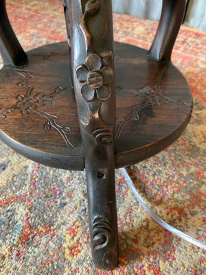 A carved wooden Chinoiserie floor lamp