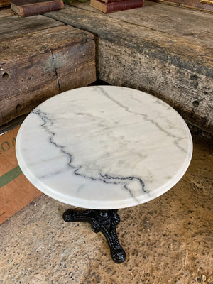 A black cast iron bistro table with marble top 1/3