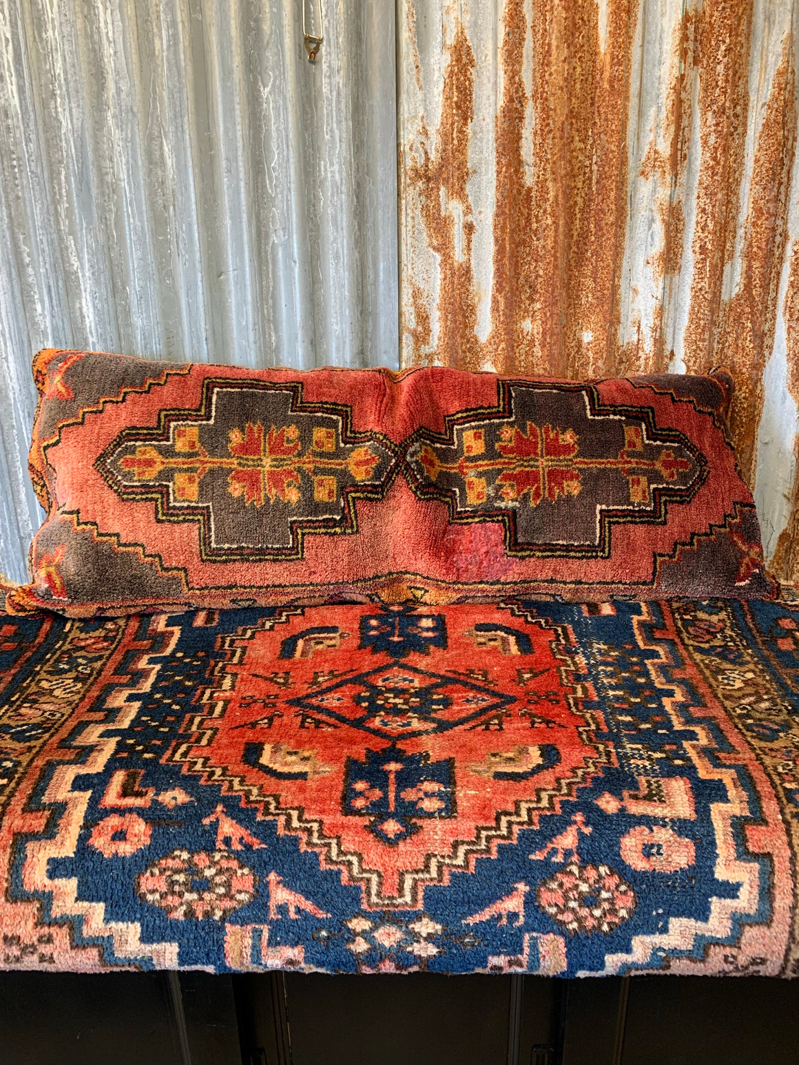 A large Persian carpet cushion