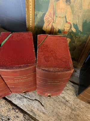 A set of five red leather and brass book boxes