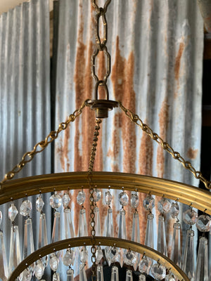 A gilt three tier crystal icicle droplet chandelier