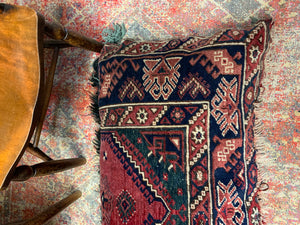 A large rectangular Persian carpet floor cushion